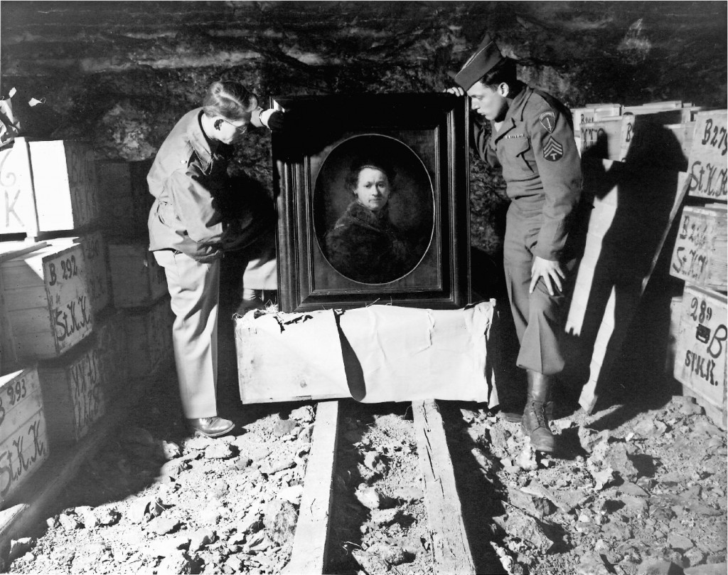 Art Second World War Heilbronn, Germany - 1946: This Self Portrait by Rembrandt, inspected by Monuments Men Dale V. Ford and Harry Ettlinger (right), was stored for safe-keeping by museum officals from Karlsruhe in the Heilbronn mine. The painting was ultimately returned to the Karlsruhe Museum. This was just one of thousands of paintings and other works of art which were found in Heilbronn as can be seen by the crates stacked behind each man. (National Archives and Records Administration, MD)
